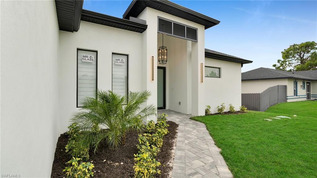 1138 Garibaldi Street East Lehigh Acres, FL 33974 - Photo 2 of 36 Entrance to property featuring stucco siding