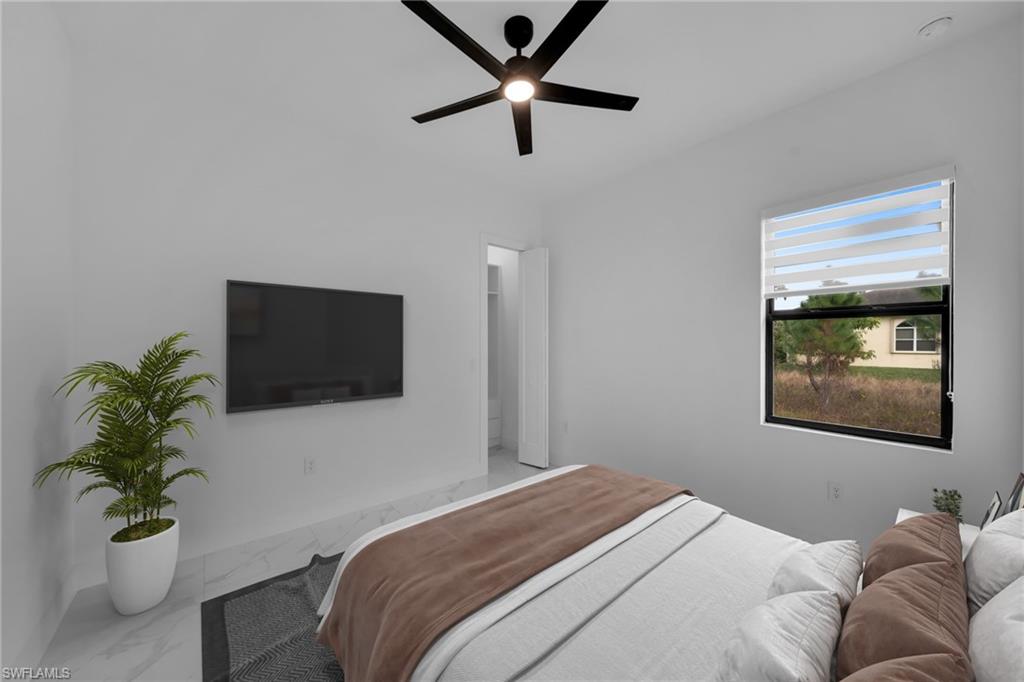 1138 Garibaldi Street East Lehigh Acres, FL 33974 - Photo 22 of 36 Bedroom with marble look tile flooring and a ceiling fan