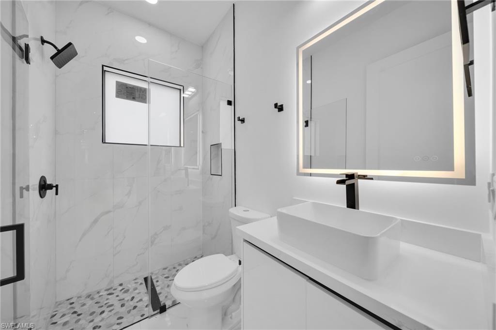 1138 Garibaldi Street East Lehigh Acres, FL 33974 - Photo 23 of 36 Bathroom with vanity, a marble finish shower, marble finish floors, and recessed lighting