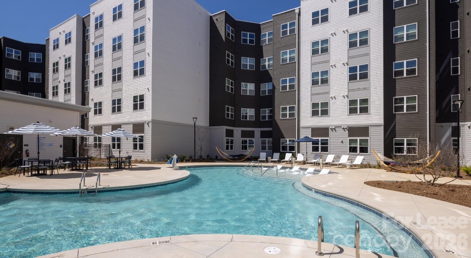 8424 North Tryon Street, Unit A2 Charlotte, NC 28262 - Photo 12 of 25 a view of a building with garden and sitting area