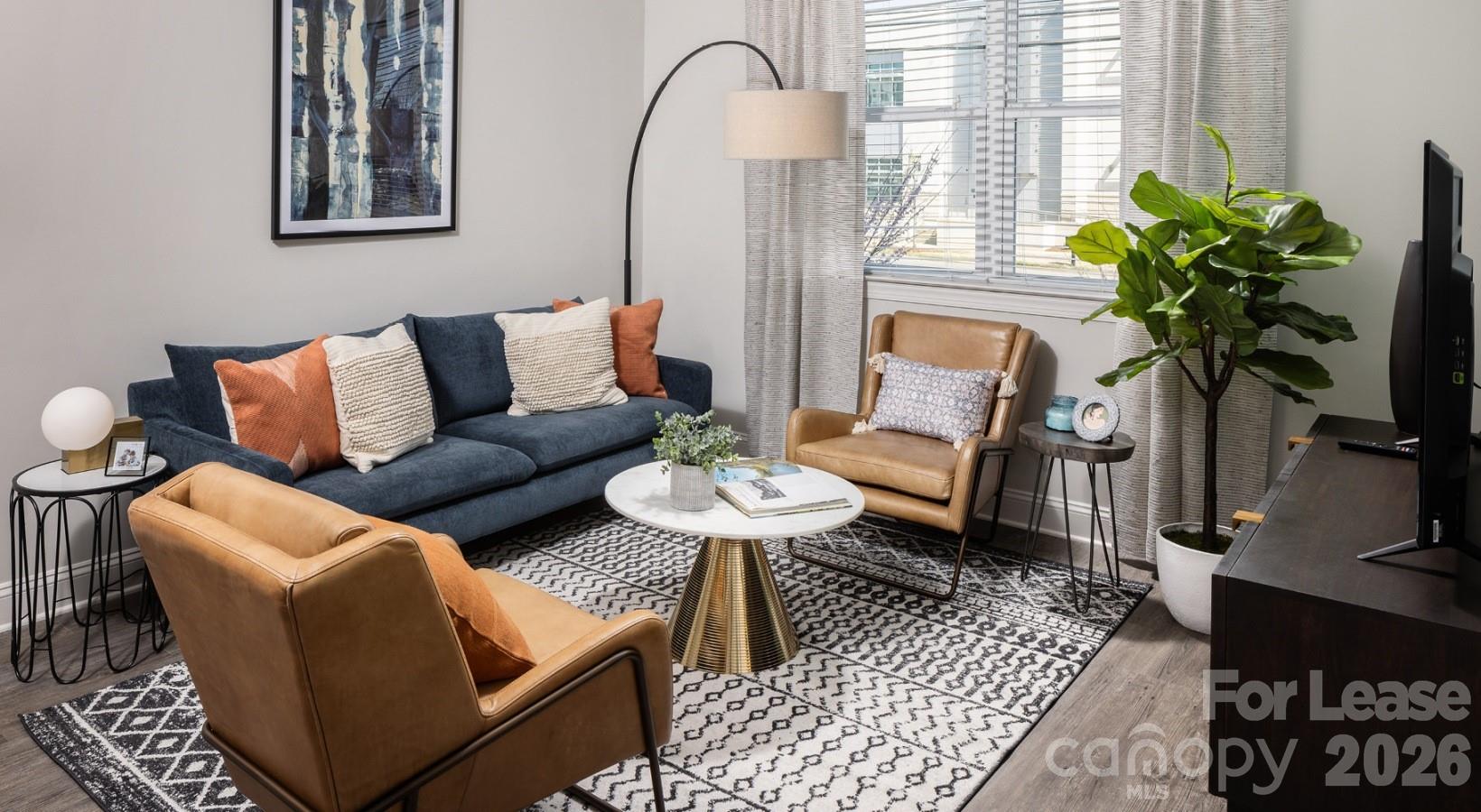 8424 North Tryon Street, Unit A2 Charlotte, NC 28262 - Photo 19 of 25 a living room with furniture flowerpot and a window