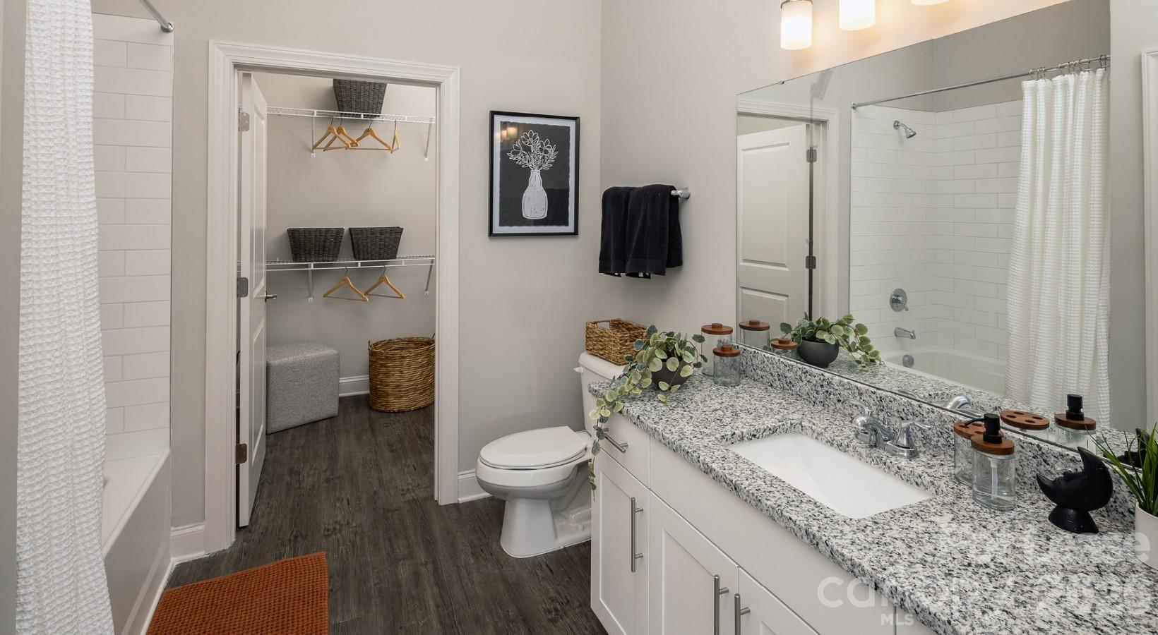 8424 North Tryon Street, Unit A2 Charlotte, NC 28262 - Photo 22 of 25 a bathroom with a granite countertop sink toilet and shower