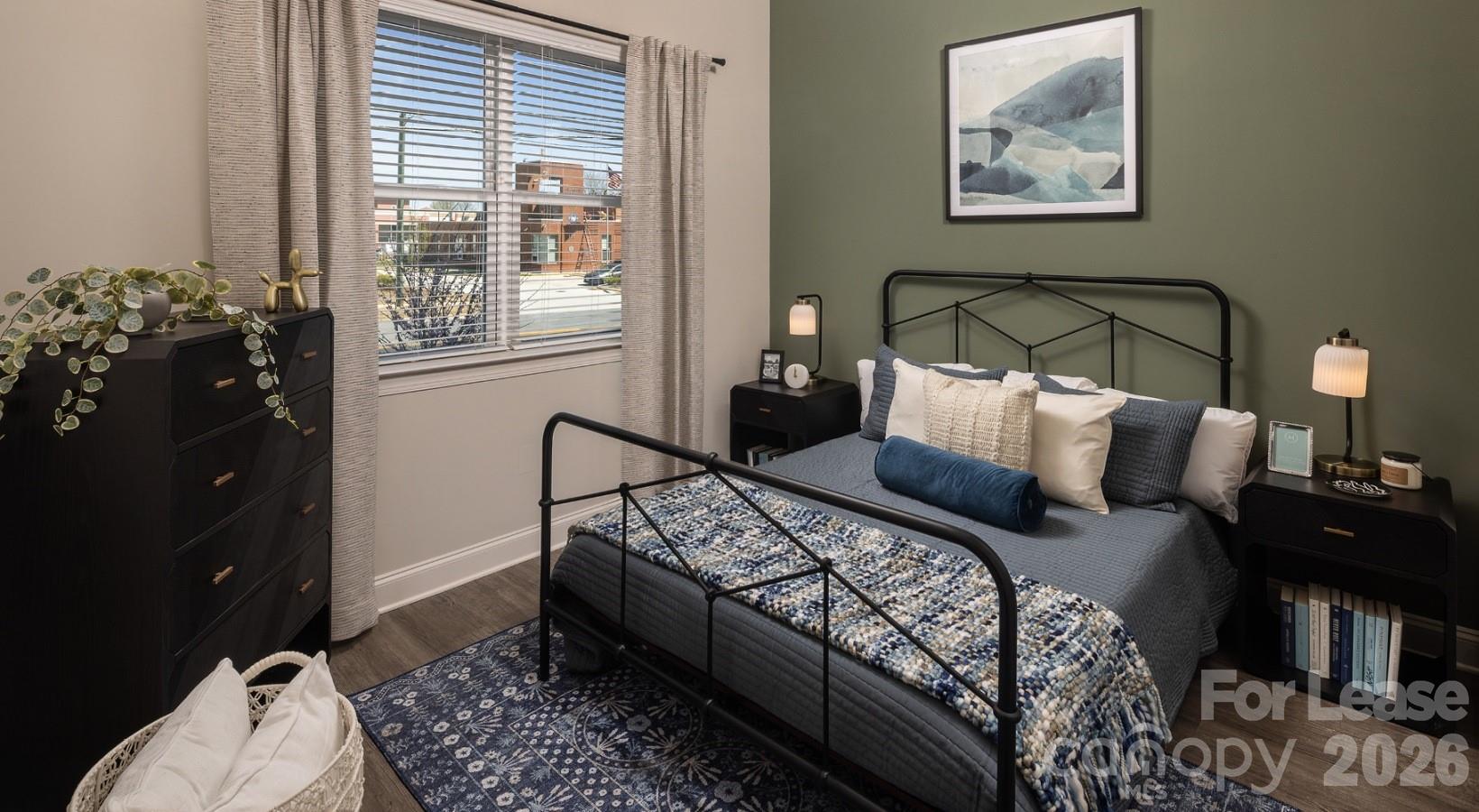 8424 North Tryon Street, Unit A2 Charlotte, NC 28262 - Photo 23 of 25 a bed room with a bed and a lamp