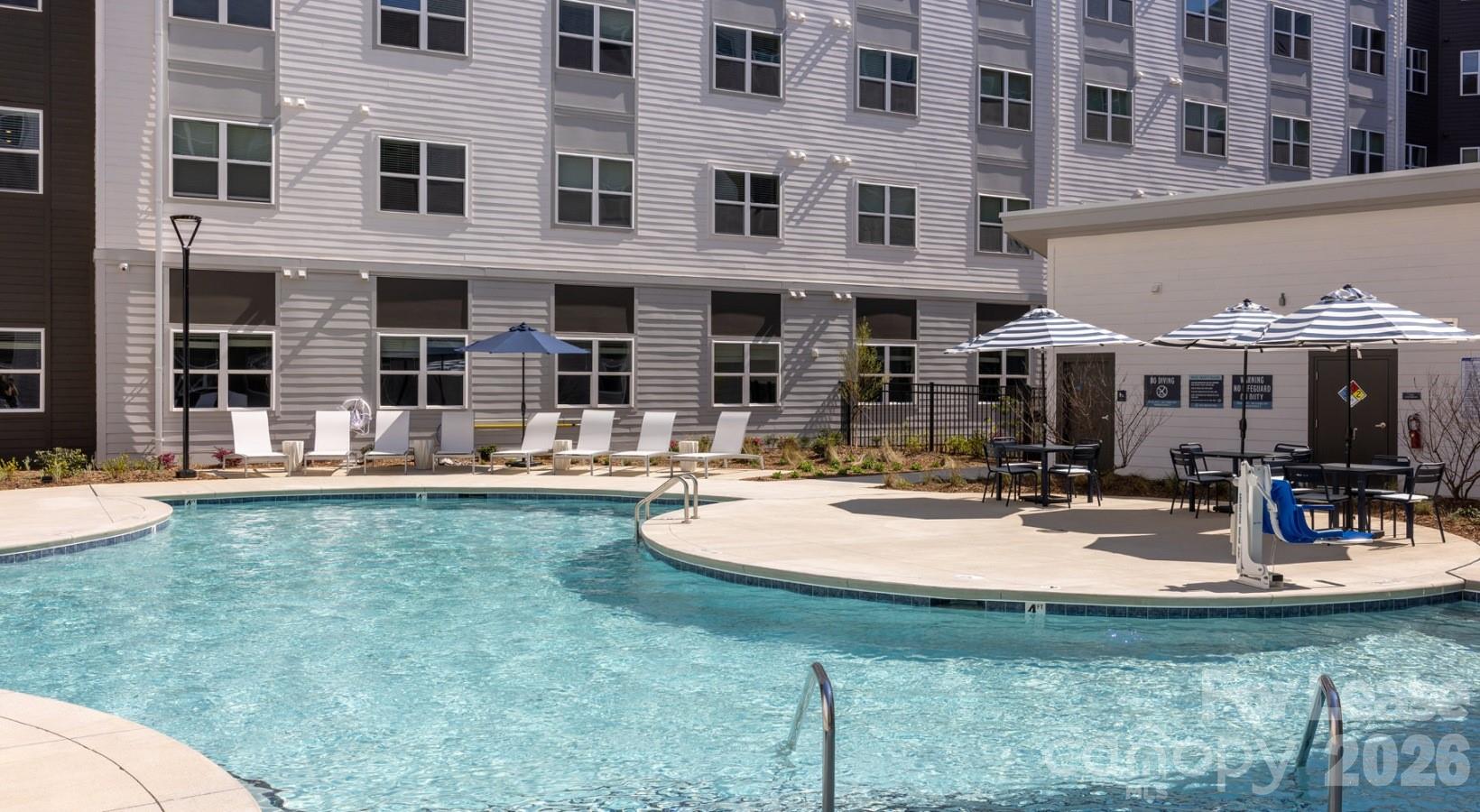 8424 North Tryon Street, Unit A2 Charlotte, NC 28262 - Photo 25 of 25 a view of a building with a fountain and sitting area