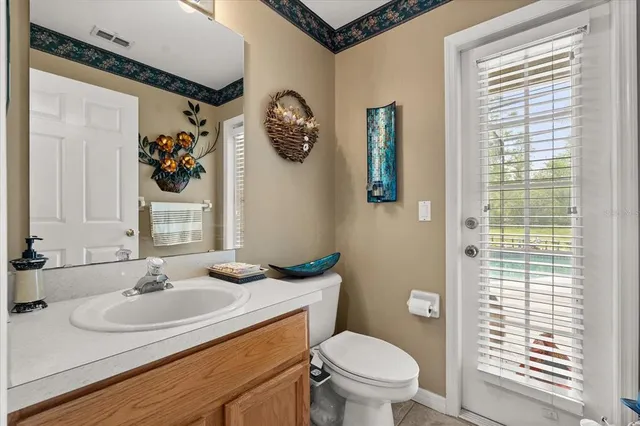 a spacious bedroom with a bed and a chandelier