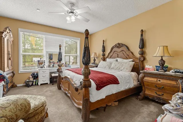 a bedroom with a large bed and a chandelier