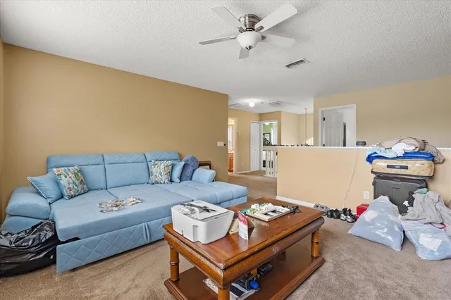 an empty room with a ceiling fan and a window
