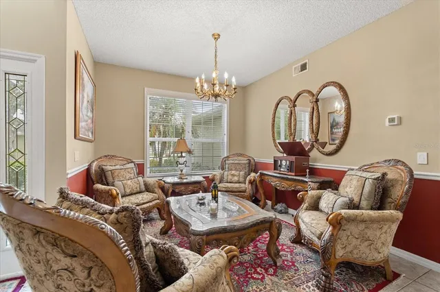a living room with furniture a rug and a chandelier