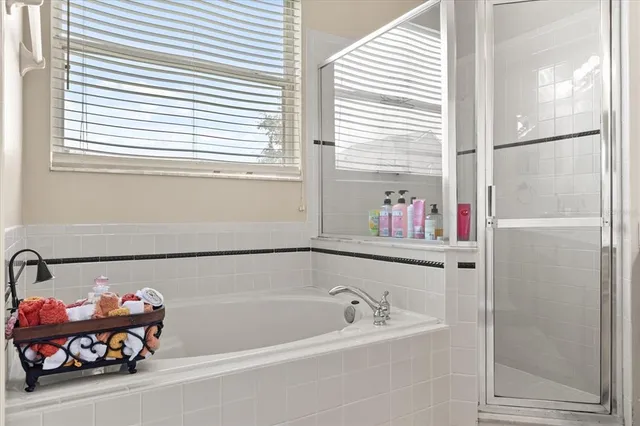 an empty room with a ceiling fan and a window