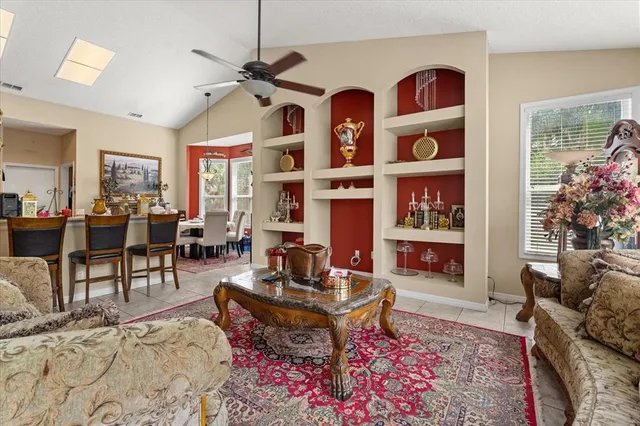 a living room with furniture a rug and a chandelier