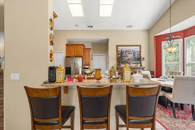 a view of a dining room with furniture and a window