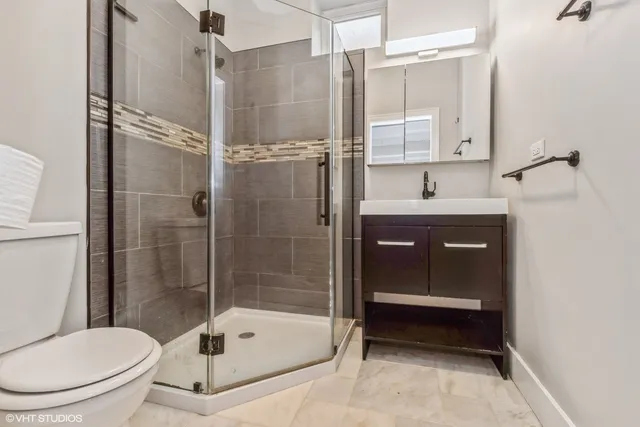 a bathroom with a toilet and a shower