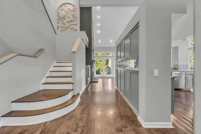 a kitchen with stainless steel appliances granite countertop a sink stove and wooden floor