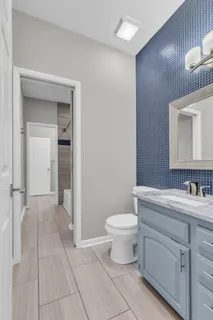 a bathroom with a toilet a sink and mirror
