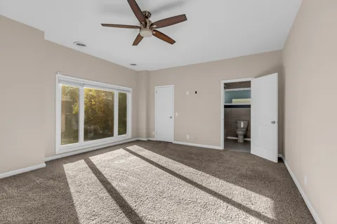 a view of a livingroom with a ceiling fan and window