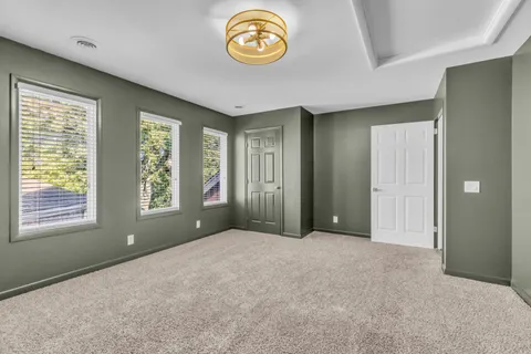 an empty room with windows and city view