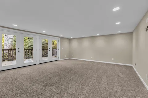 a view of an empty room with a fireplace and a large window