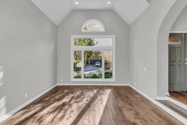 a view of livingroom with entryway and hallway view with wooden floor