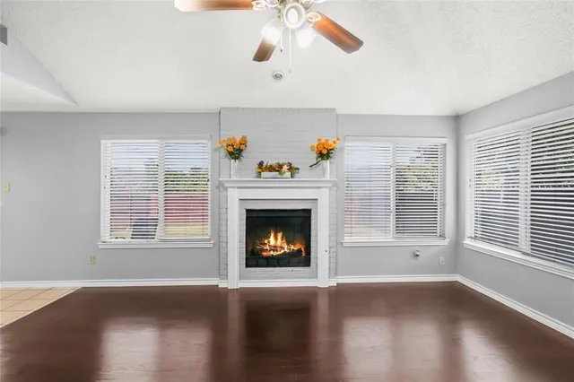 a view of a hallway with wooden floor and a chandelier