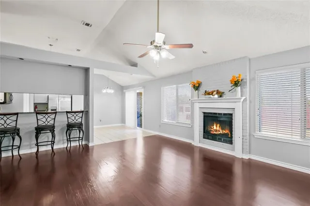 a living room with a fireplace and wooden floor
