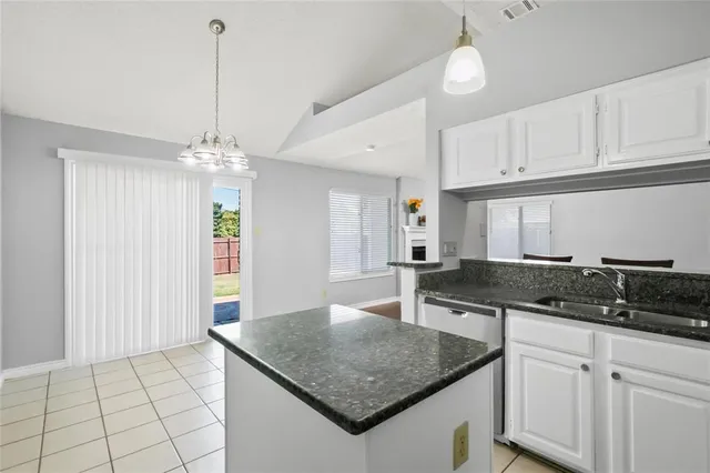 a kitchen with stainless steel appliances granite countertop a sink stove and microwave