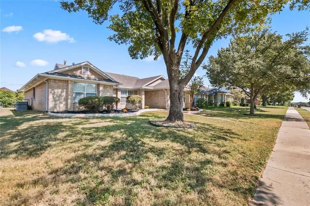 a kitchen with stainless steel appliances granite countertop a sink a stove cabinets and a counter top space