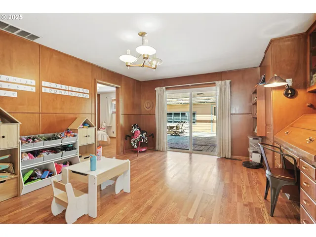 a living room with furniture a flat screen tv and a window