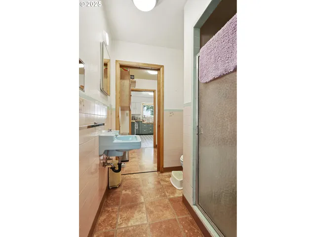 a view of a room with a chair and floor to ceiling window