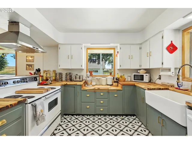a kitchen that has a sink and a stove in it