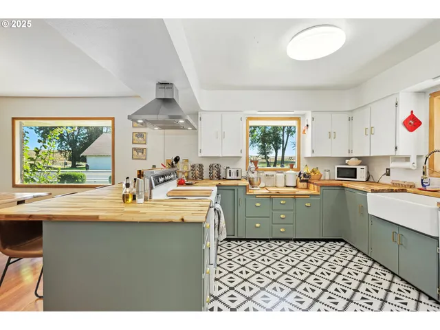 a kitchen with a sink window and cabinets