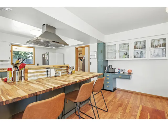 a view of a dining room with furniture and a chandelier