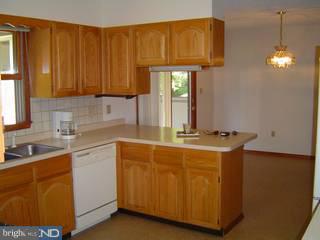 1830 Almonesson Road Woodbury, NJ 08096 - Photo 5 of 6 a kitchen with stainless steel appliances granite countertop a sink a refrigerator and a stove