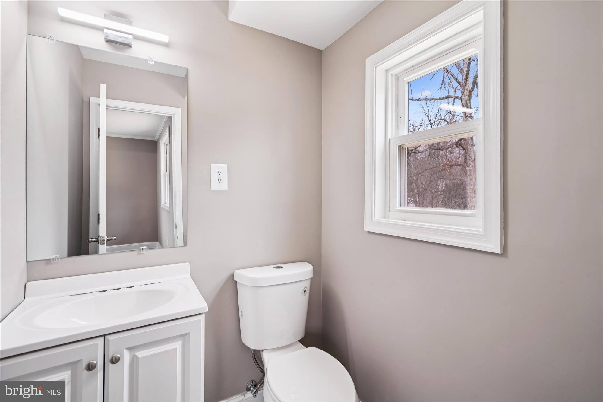 6473 Anderson Avenue Hanover, MD 21076 - Photo 11 of 27 a bathroom with a toilet sink and mirror