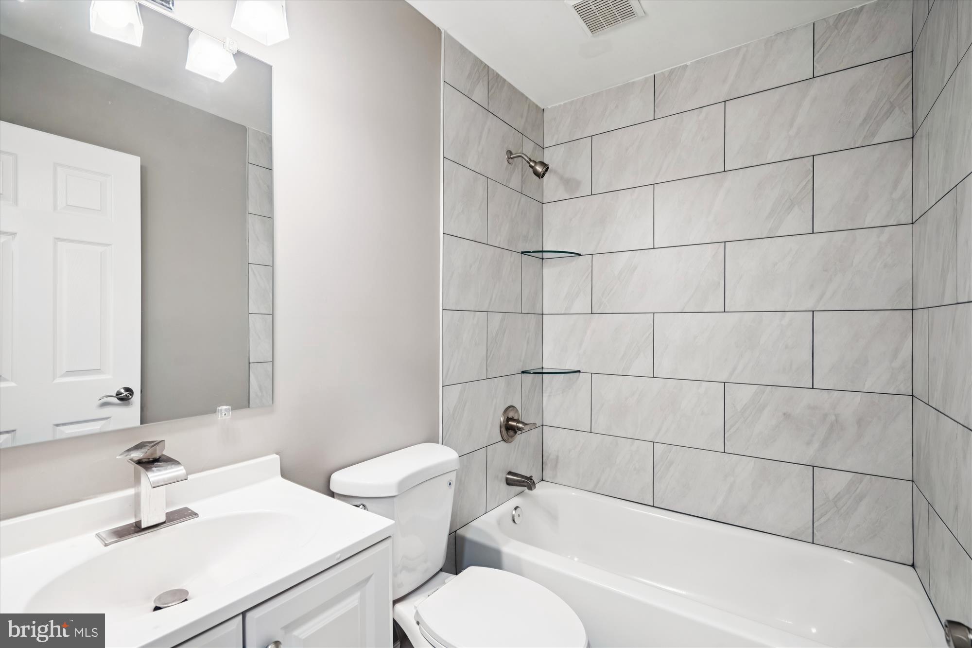 6473 Anderson Avenue Hanover, MD 21076 - Photo 14 of 27 a bathroom with a sink toilet and shower