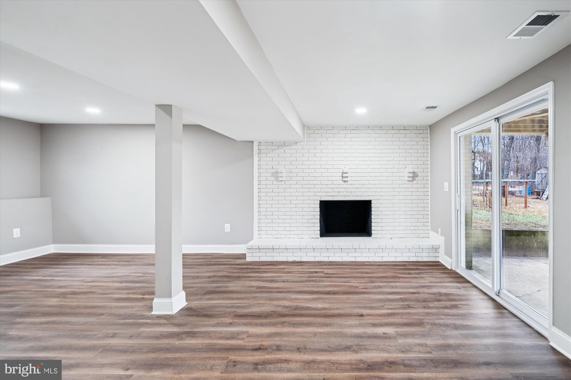 6473 Anderson Avenue Hanover, MD 21076 - Photo 15 of 27 a view of a hallway with a fireplace and wooden floor