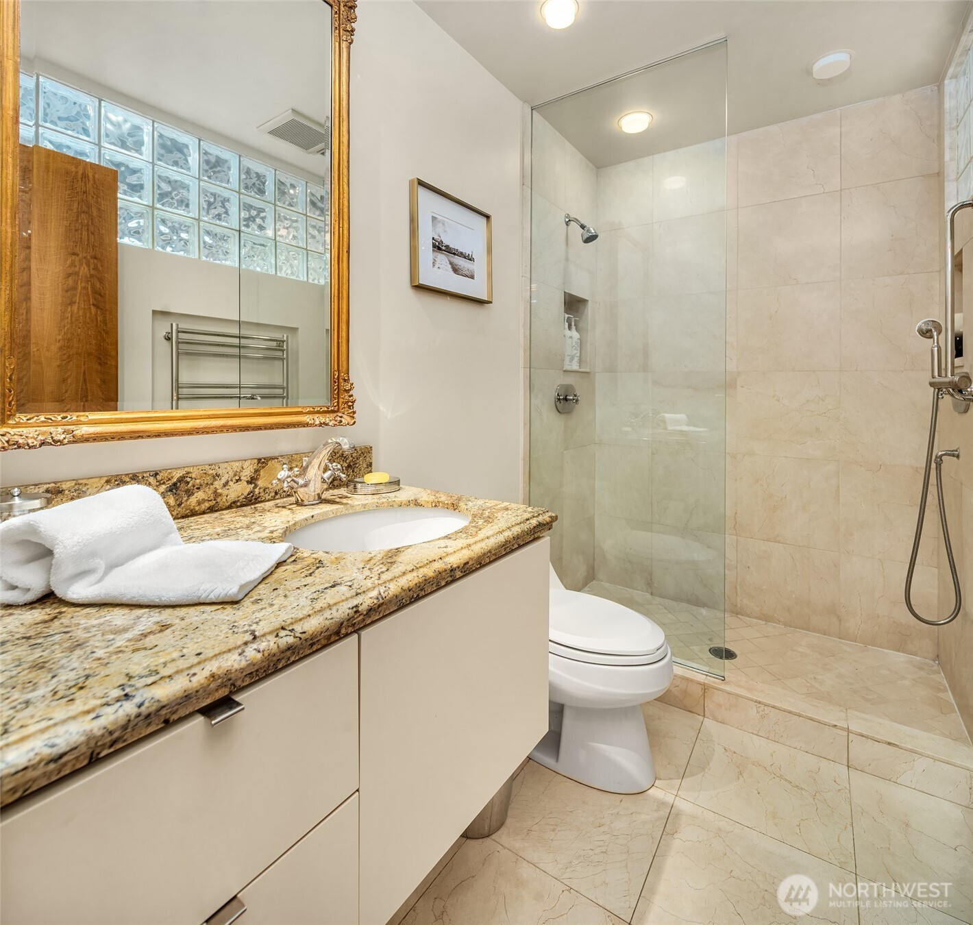 87 Virginia Street, Unit 8 Seattle, WA 98101 - Photo 21 of 34 a bathroom with a granite countertop sink toilet and shower