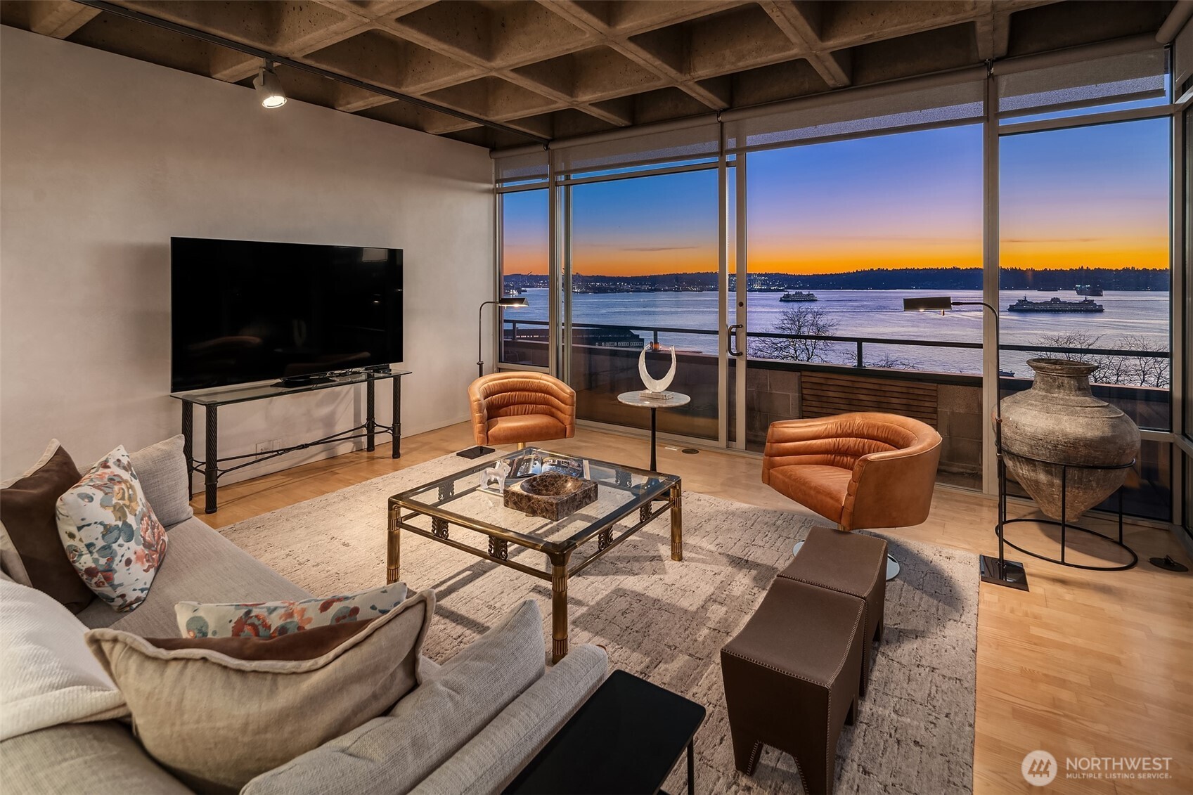 87 Virginia Street, Unit 8 Seattle, WA 98101 - Photo 3 of 34 a living room with furniture a flat screen tv and kitchen view