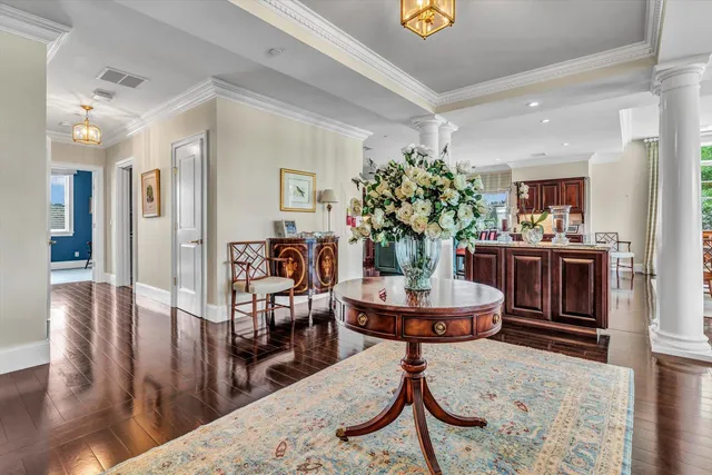 a room with stainless steel appliances kitchen island granite countertop a dining table and chairs