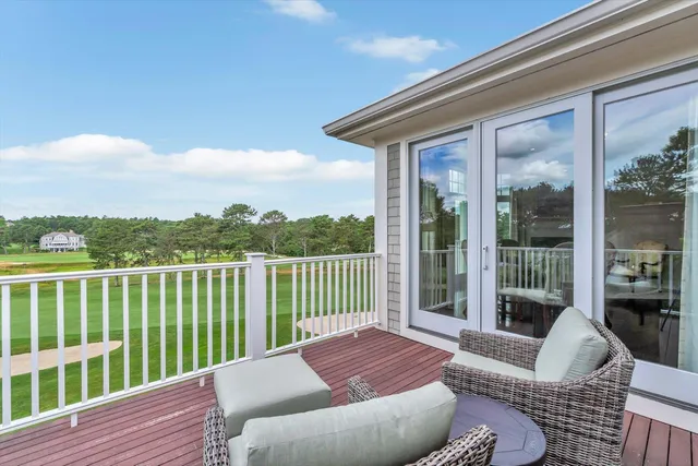 a balcony with furniture and wooden floor