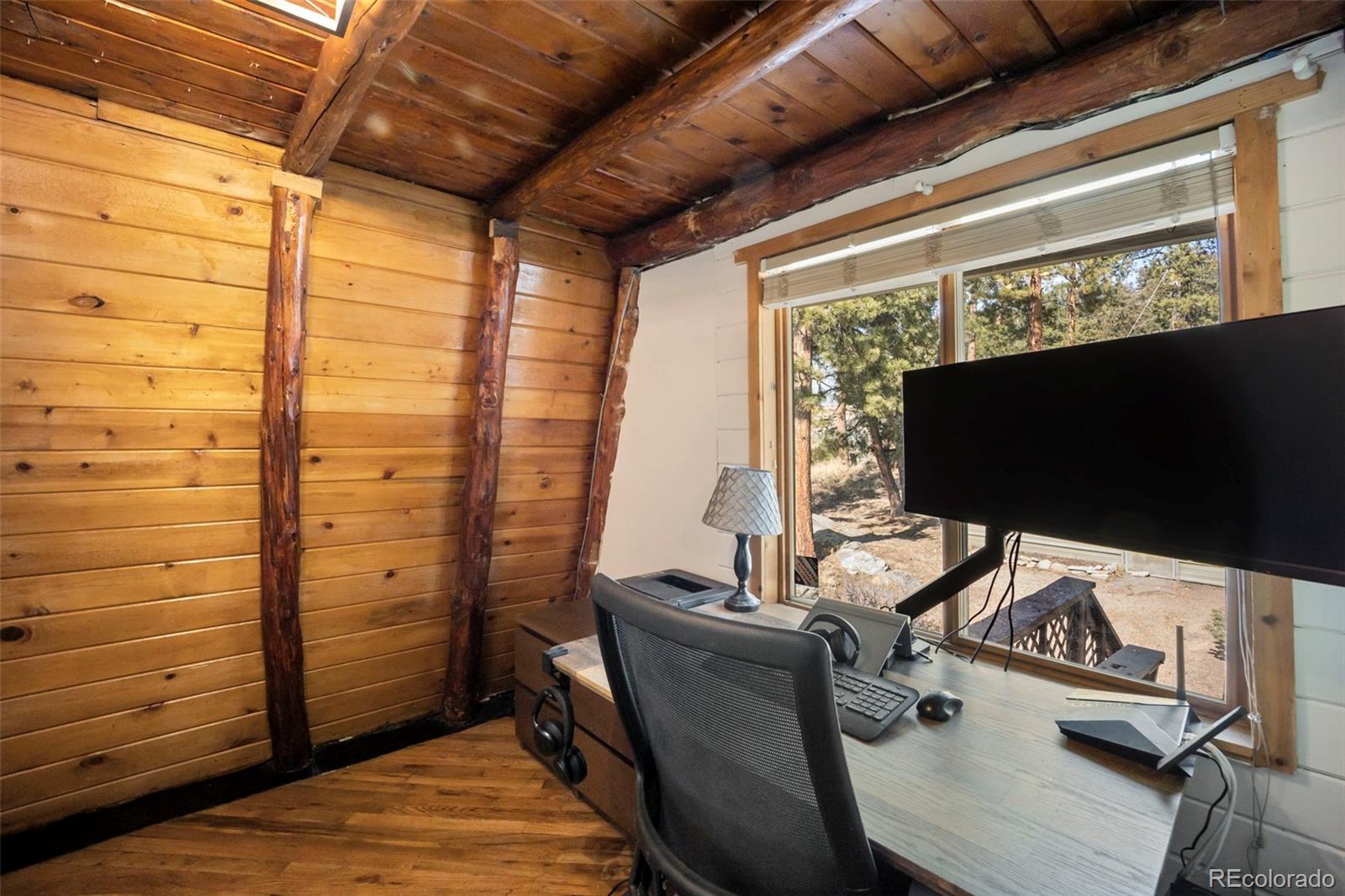 25874 Mosier Street Conifer, CO 80433 - Photo 11 of 45 a room with furniture and flat screen tv