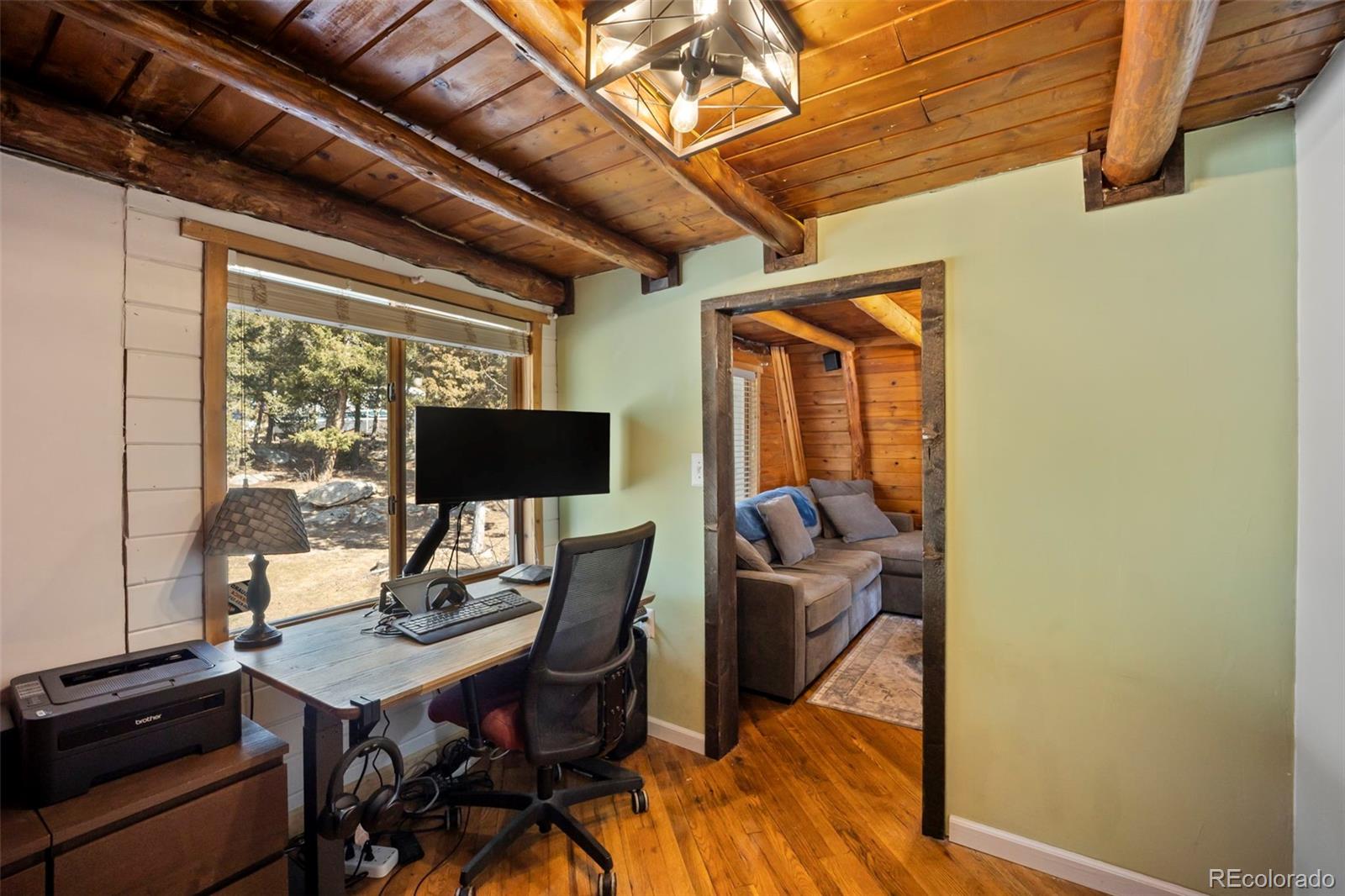 25874 Mosier Street Conifer, CO 80433 - Photo 12 of 45 a view of a dining room with furniture window and outside view