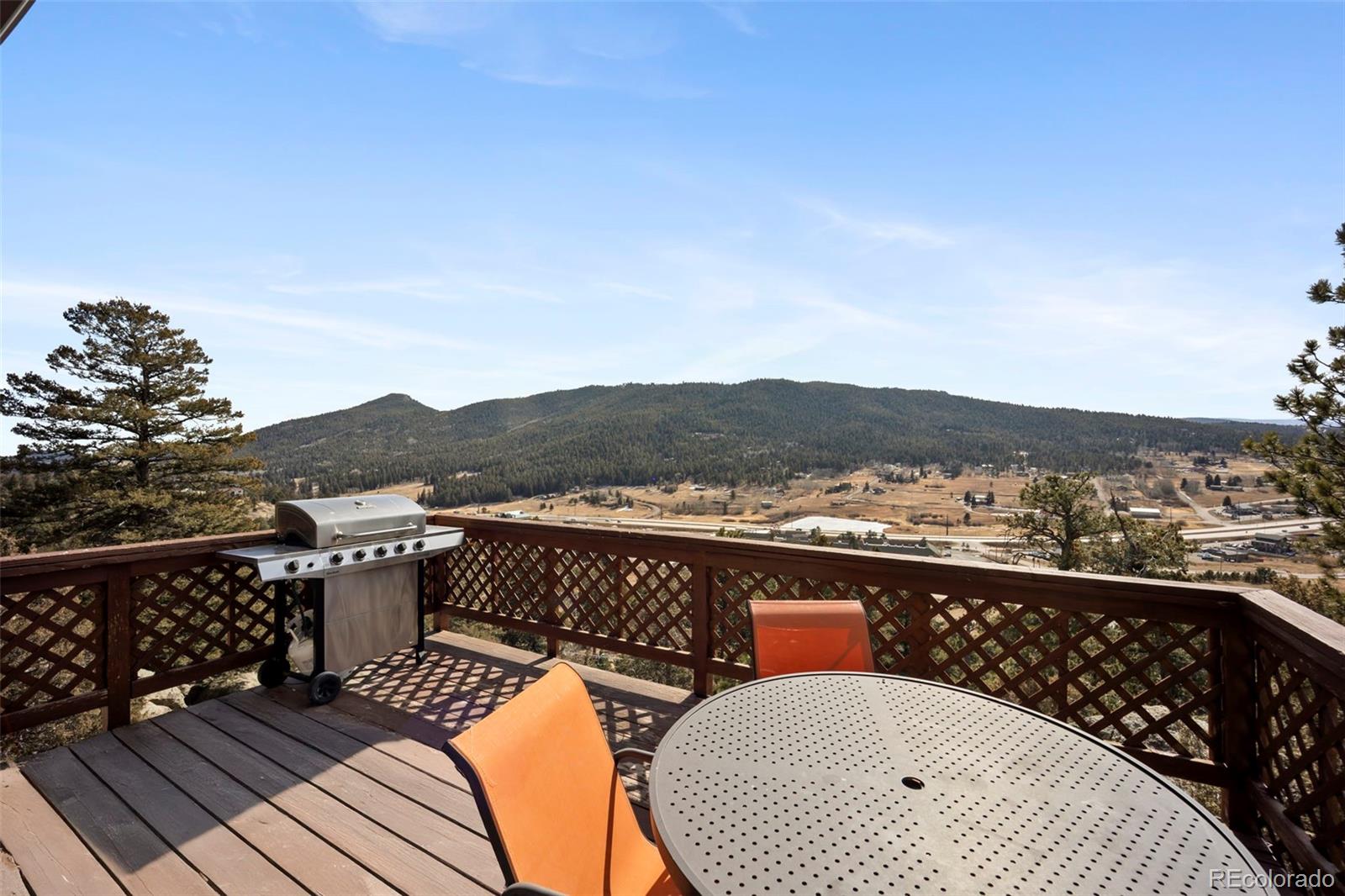 25874 Mosier Street Conifer, CO 80433 - Photo 17 of 45 a terrace of a house with outdoor seating