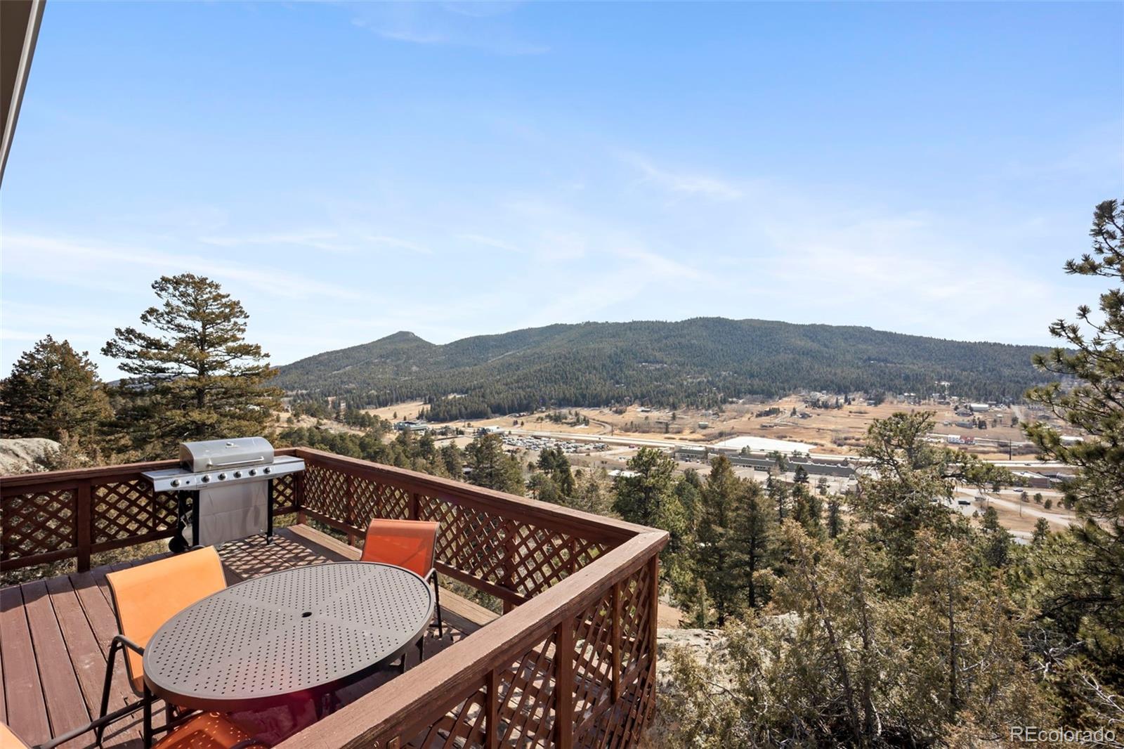 25874 Mosier Street Conifer, CO 80433 - Photo 20 of 45 a view of a balcony with chair and wooden floor