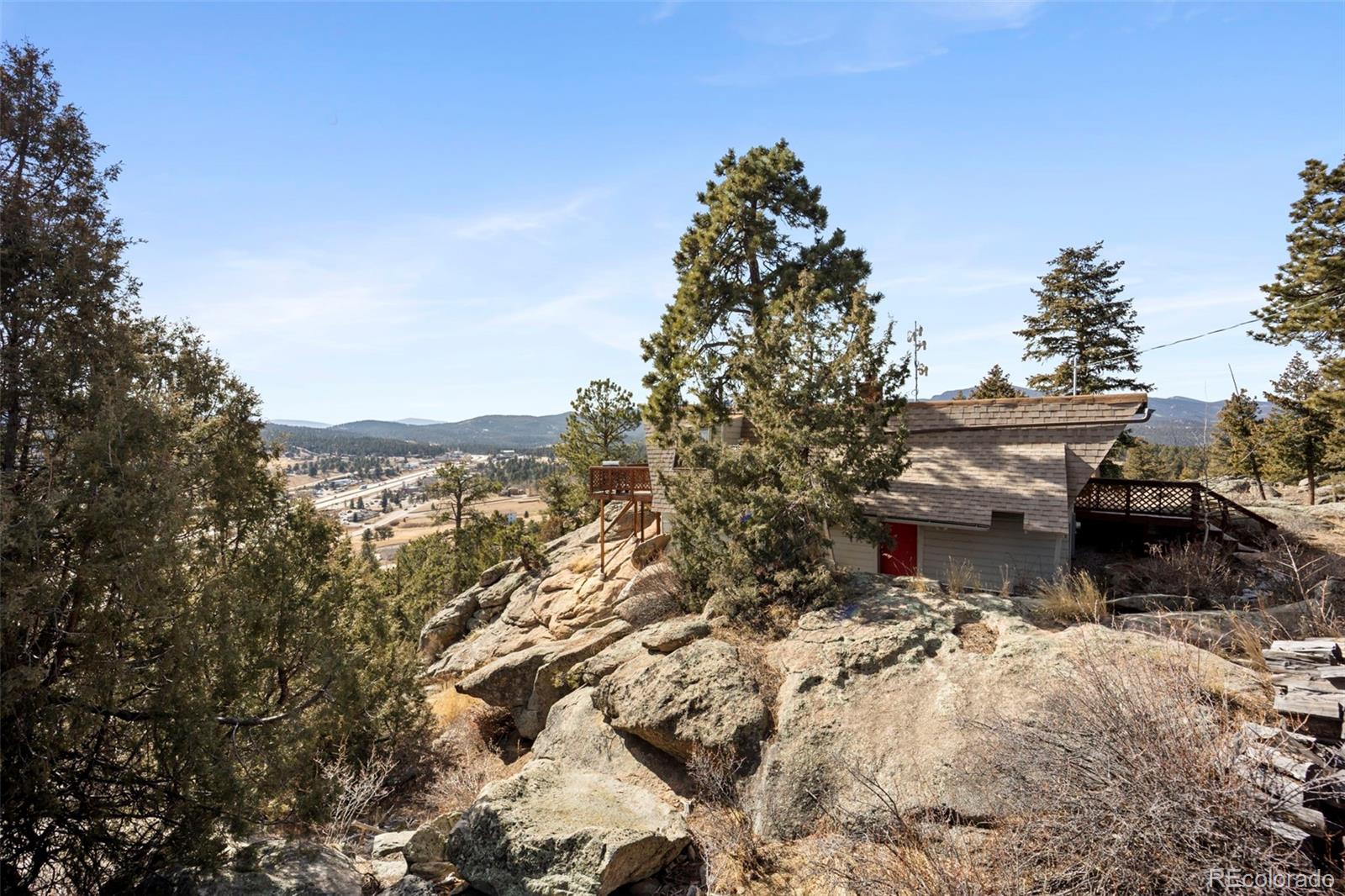 25874 Mosier Street Conifer, CO 80433 - Photo 25 of 45 a view of a house with a yard and sitting area