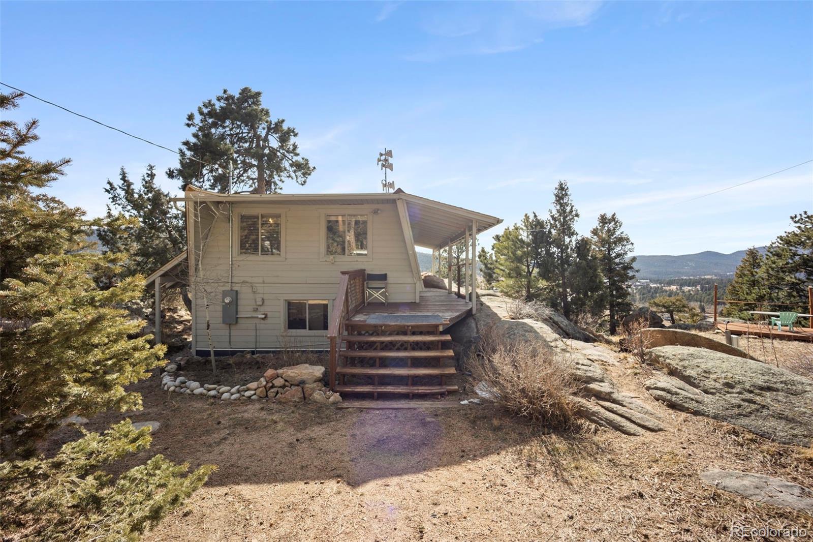 25874 Mosier Street Conifer, CO 80433 - Photo 29 of 45 a front view of a house with a yard