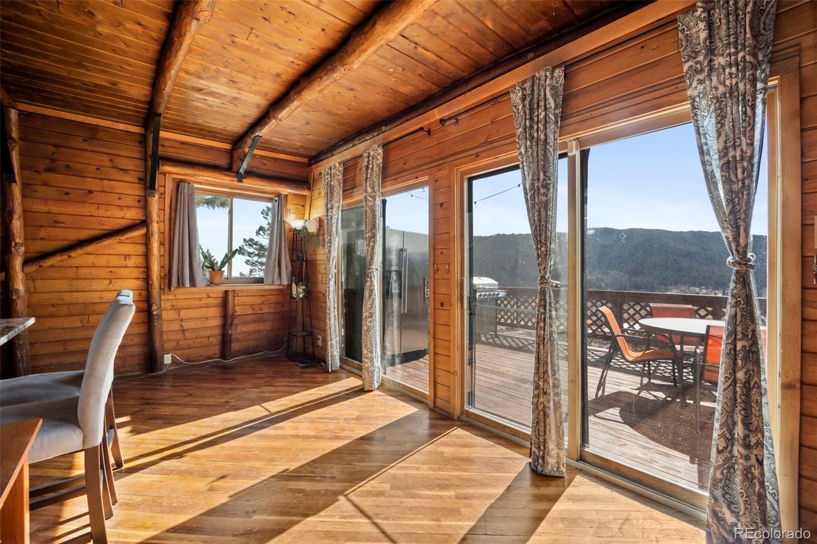 25874 Mosier Street Conifer, CO 80433 - Photo 6 of 45 a porch with a glass door and porch