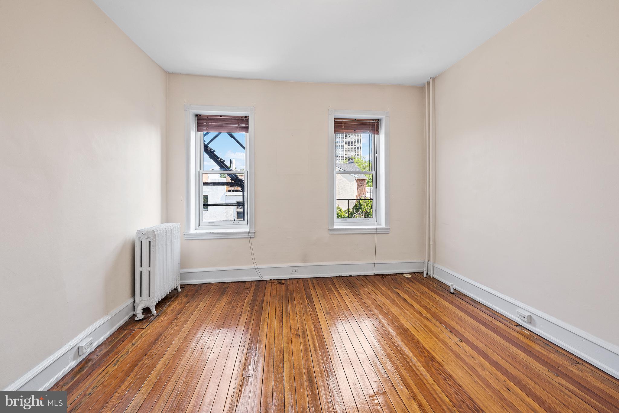 231 Pine Street, Unit 2 Philadelphia, PA 19106 - Photo 17 of 23 an empty room with wooden floor and windows