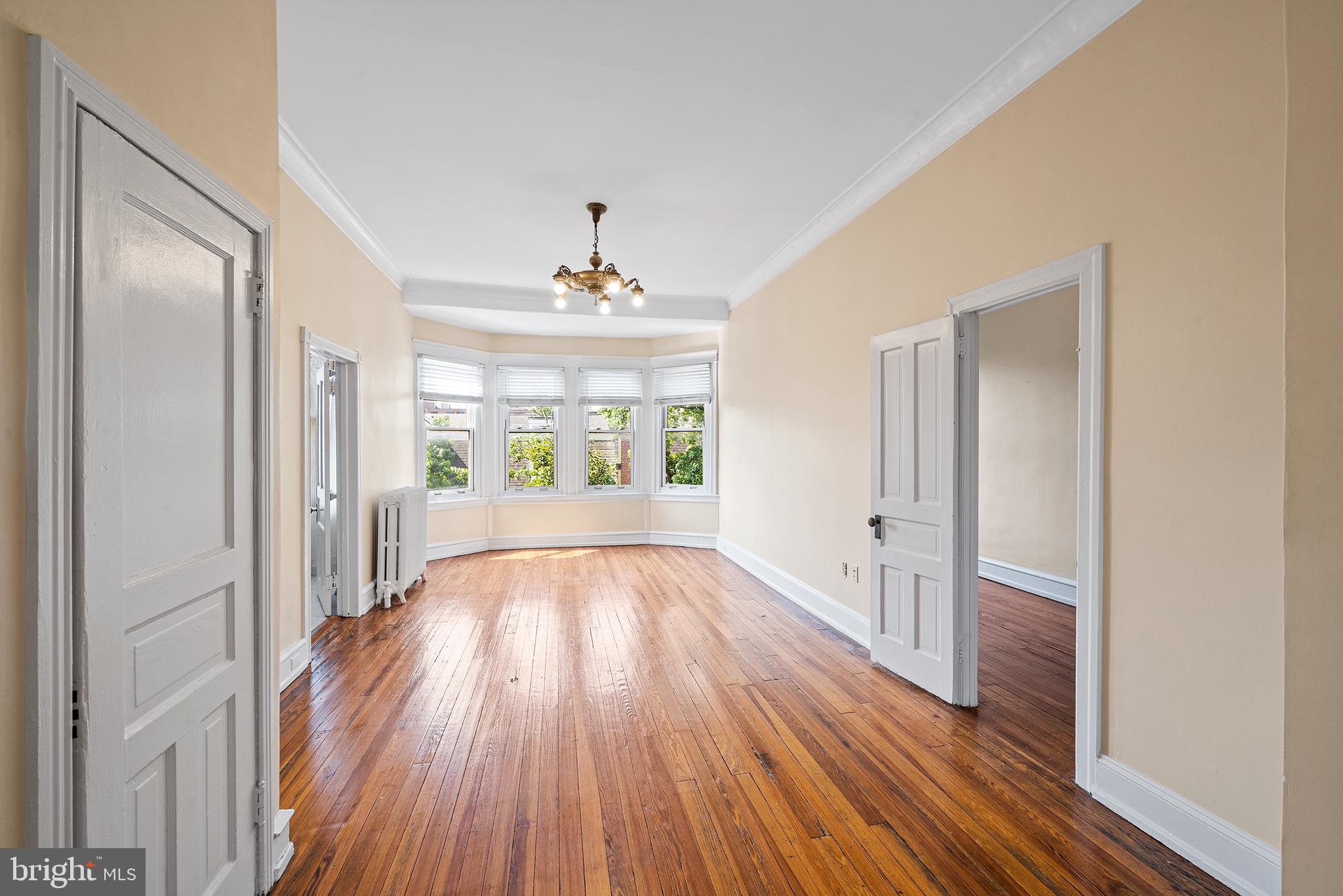 231 Pine Street, Unit 2 Philadelphia, PA 19106 - Photo 20 of 23 a view of an empty room with wooden floor and a window