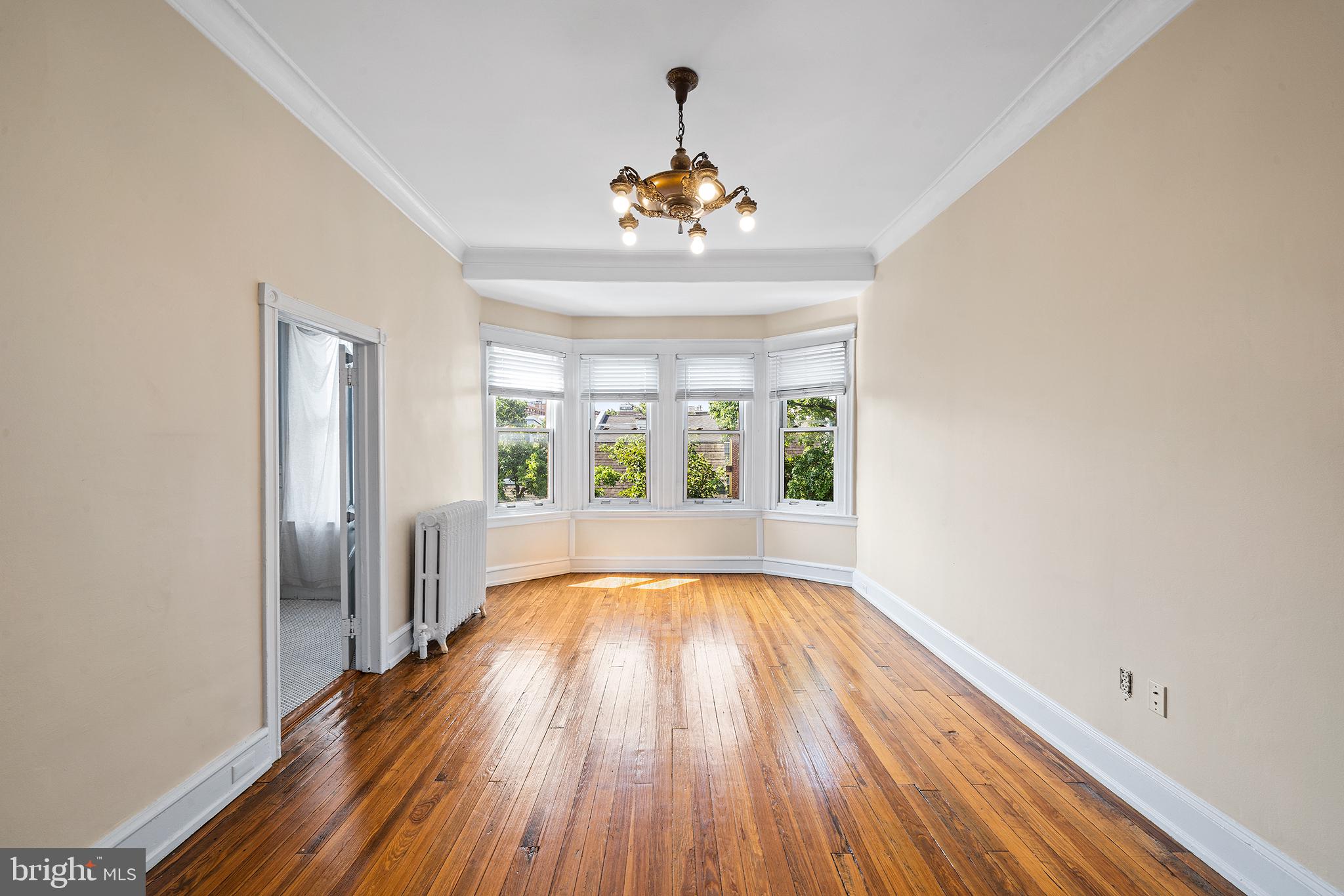 231 Pine Street, Unit 2 Philadelphia, PA 19106 - Photo 21 of 23 a view of an empty room with wooden floor and a window