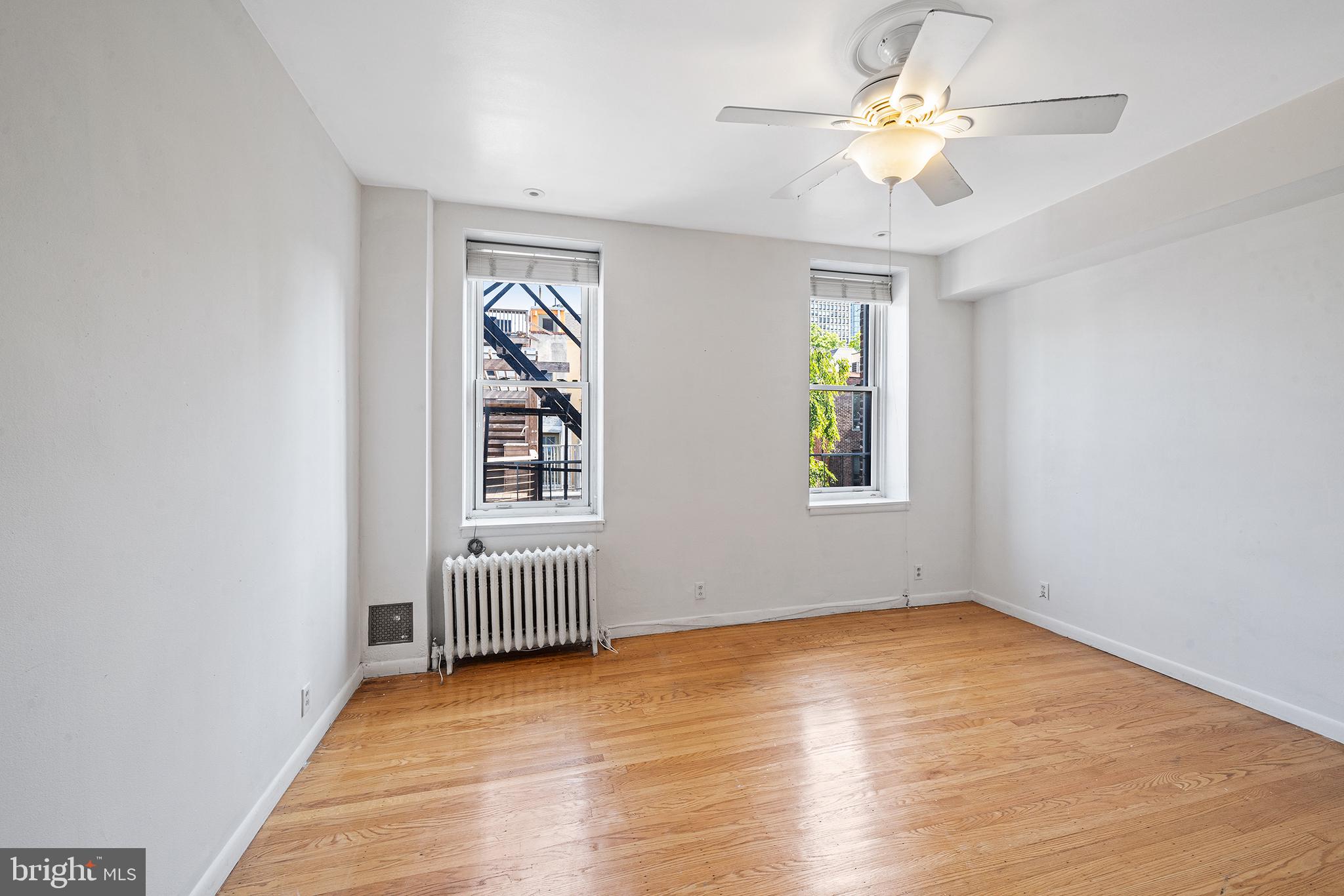 231 Pine Street, Unit 2 Philadelphia, PA 19106 - Photo 9 of 23 a view of an empty room with window and wooden floor